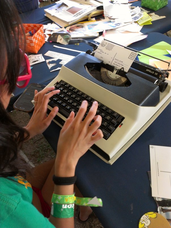 Typing up a postcard at the activities tent
