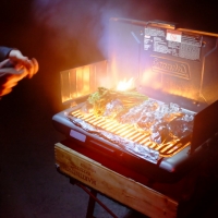 Three pieces of salmon, and a pound of asparagus over flaming steak